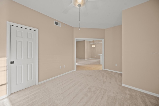 spare room with light carpet and ceiling fan