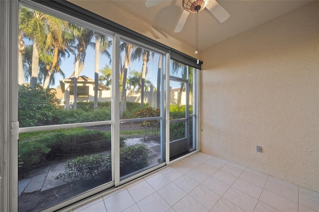 unfurnished sunroom featuring ceiling fan