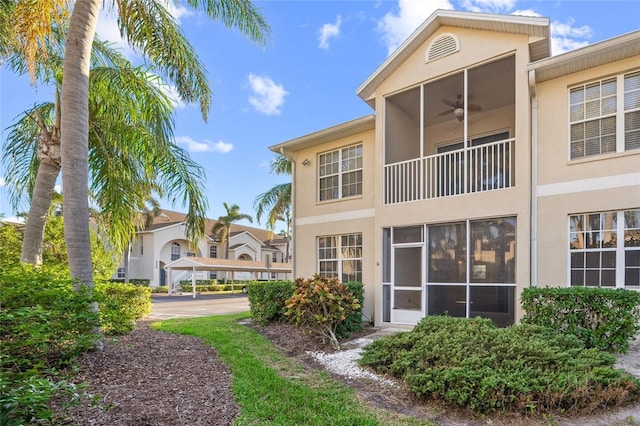 rear view of property with ceiling fan