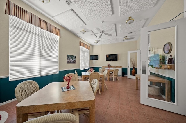 dining space featuring tile patterned floors and ceiling fan