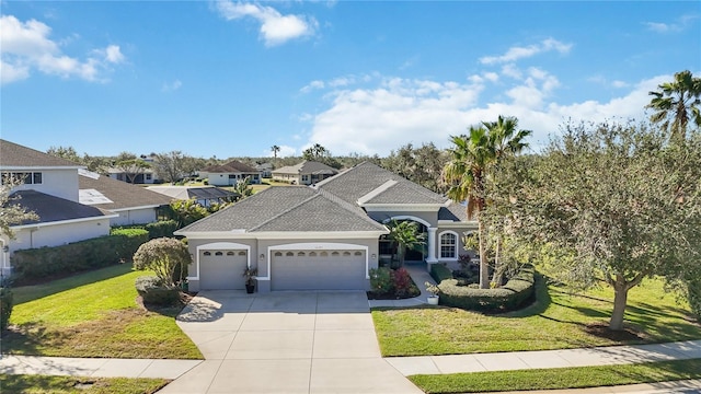 front facade featuring a front yard and a garage