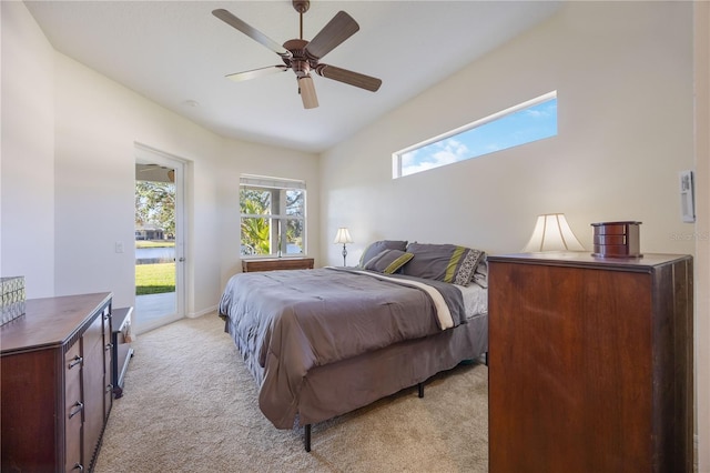 carpeted bedroom featuring access to outside, ceiling fan, and lofted ceiling