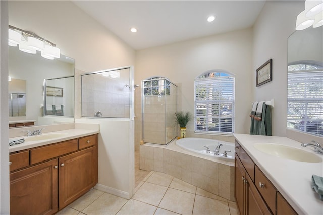 bathroom with separate shower and tub, a wealth of natural light, tile patterned flooring, and vanity