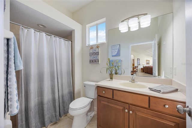 bathroom with tile patterned floors, vanity, toilet, and curtained shower