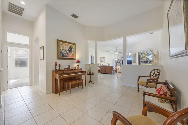 interior space with light tile patterned floors, a ceiling fan, and visible vents