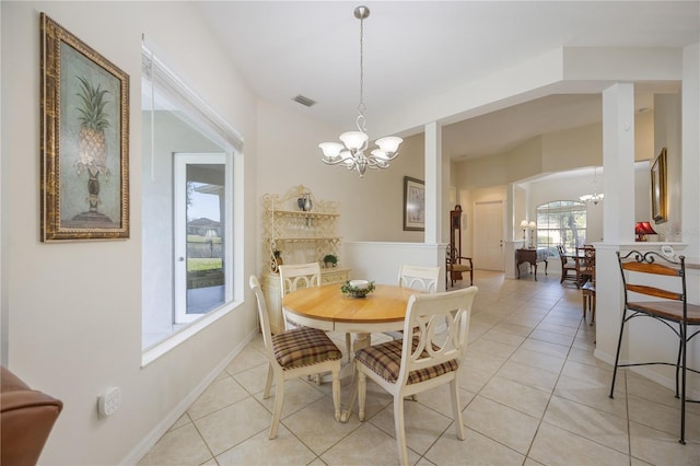 dining area with an inviting chandelier, light tile patterned floors, and visible vents