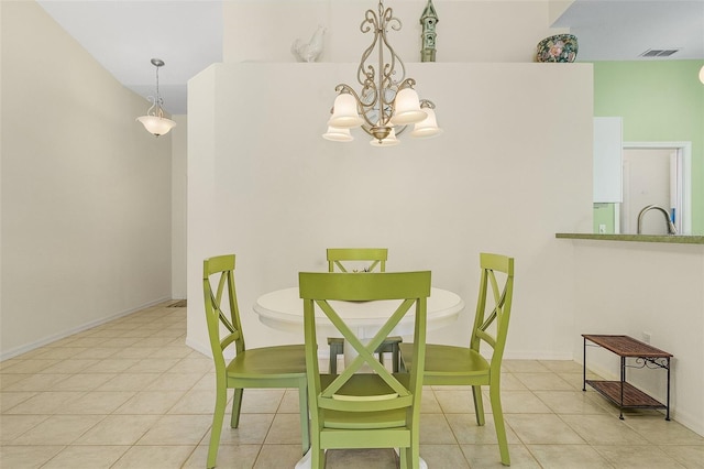 tiled dining room featuring a chandelier