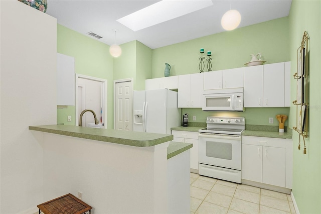 kitchen featuring kitchen peninsula, a skylight, white appliances, white cabinets, and hanging light fixtures