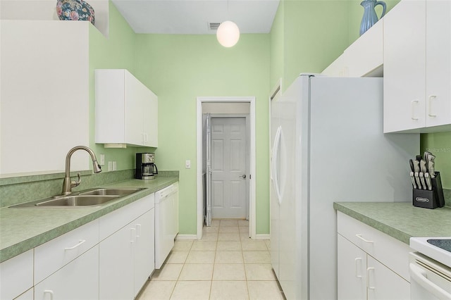 kitchen with hanging light fixtures, white cabinetry, and sink