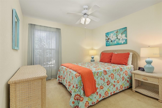 bedroom featuring light colored carpet and ceiling fan