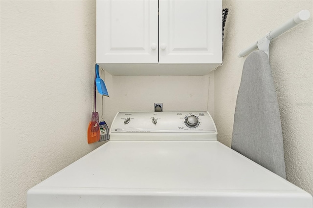 washroom with cabinets and washer / clothes dryer