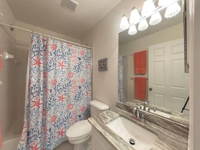 bathroom with vanity, toilet, and curtained shower