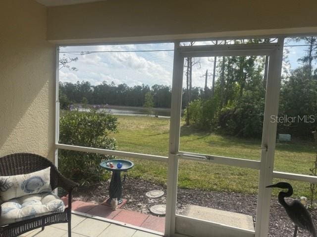 sunroom / solarium with a water view