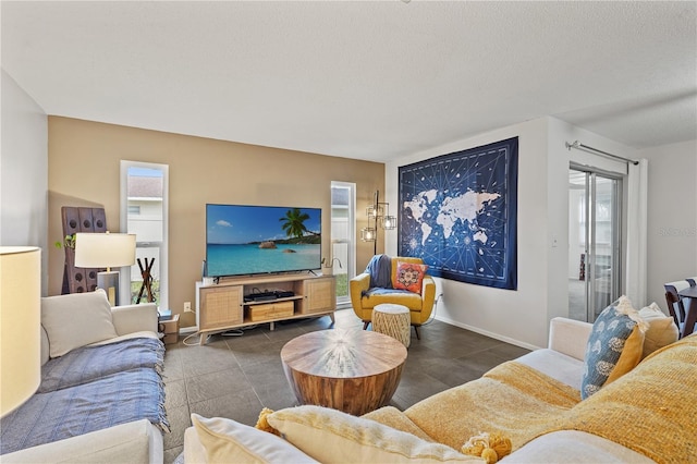 living area featuring baseboards and a textured ceiling