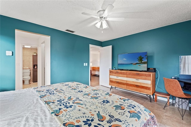 bedroom featuring tile patterned flooring, visible vents, ceiling fan, and a textured ceiling