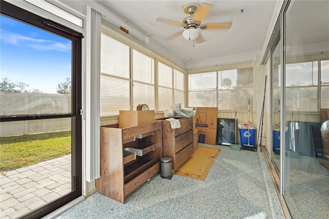 sunroom / solarium with a ceiling fan