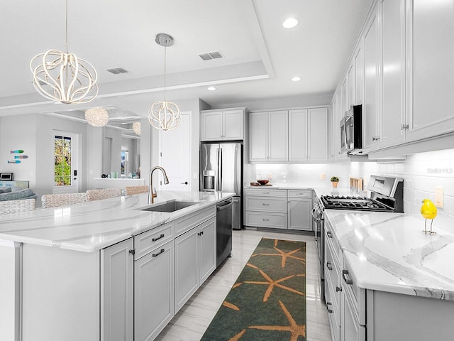 kitchen featuring a large island, decorative light fixtures, appliances with stainless steel finishes, and a chandelier