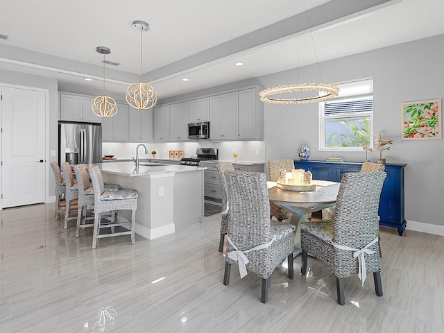 dining room featuring sink and a chandelier