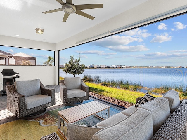 view of patio with ceiling fan, a water view, and an outdoor hangout area