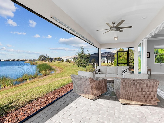 view of patio / terrace featuring ceiling fan, a water view, and an outdoor hangout area