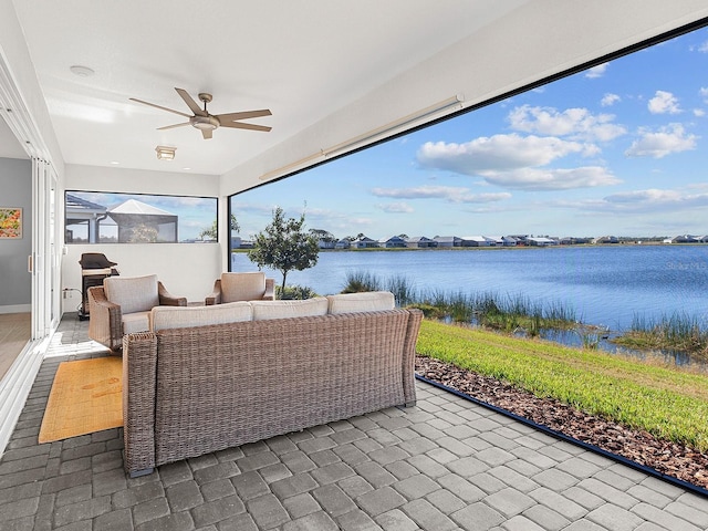 view of patio featuring outdoor lounge area, a water view, and ceiling fan