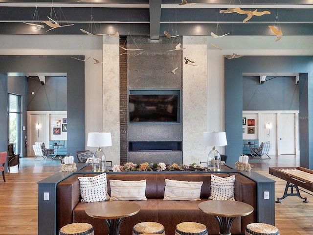 living room with wood-type flooring and a high ceiling