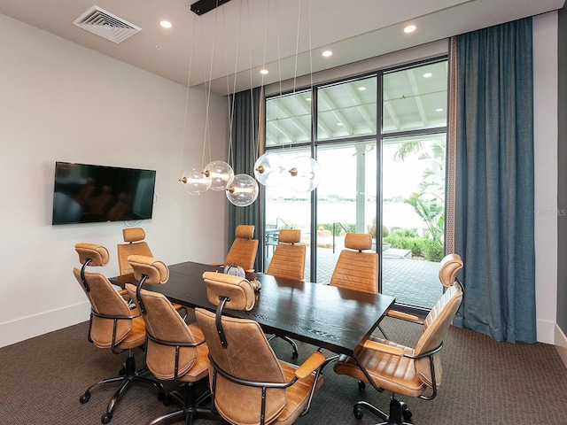 carpeted dining space with expansive windows