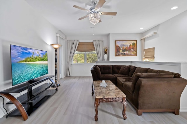 living room featuring ceiling fan and light hardwood / wood-style floors