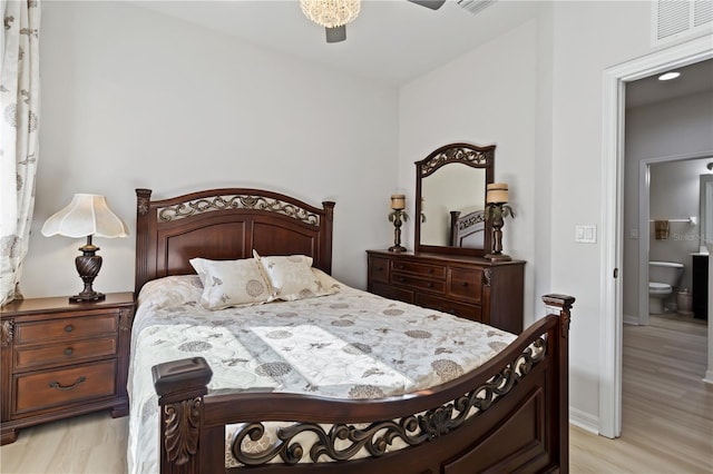 bedroom featuring connected bathroom, light hardwood / wood-style flooring, and ceiling fan