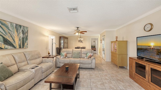 tiled living room featuring a textured ceiling, ceiling fan, and crown molding