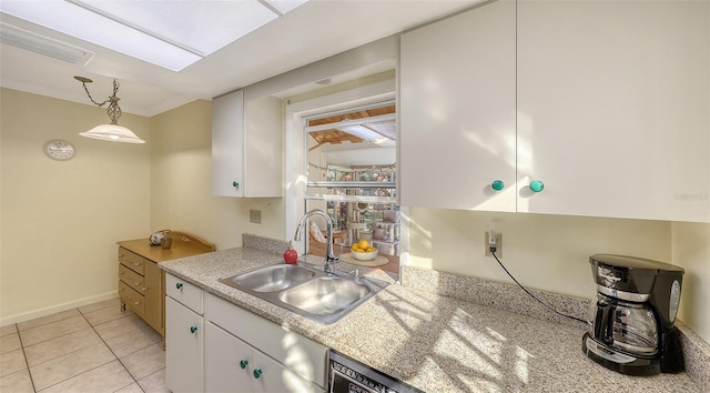 kitchen with white cabinetry, sink, light tile patterned floors, and hanging light fixtures