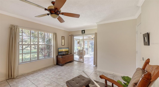 sitting room with light tile patterned floors, a textured ceiling, ceiling fan, and ornamental molding