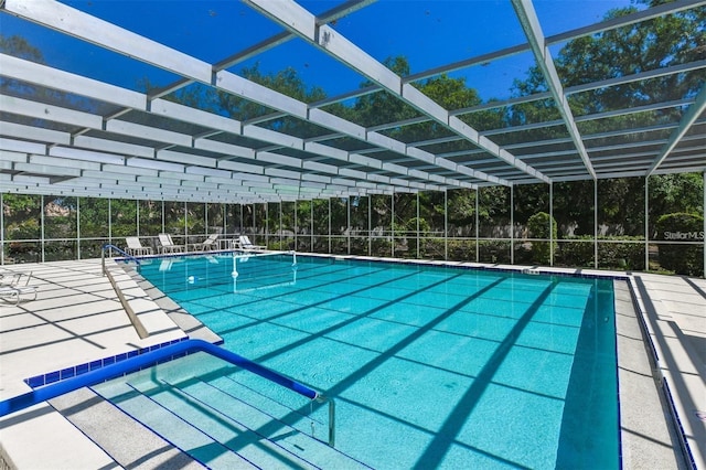 view of pool featuring a patio and glass enclosure