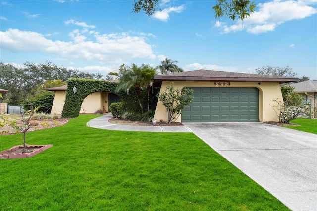 view of front of property with a garage and a front lawn