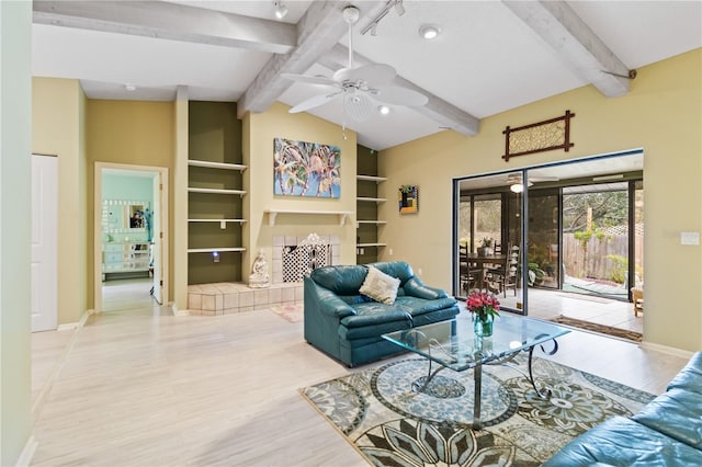 living room with light wood-type flooring, lofted ceiling with beams, ceiling fan, and a fireplace