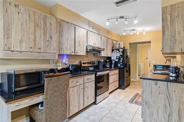 kitchen featuring radiator, light tile patterned floors, stainless steel appliances, and light brown cabinetry