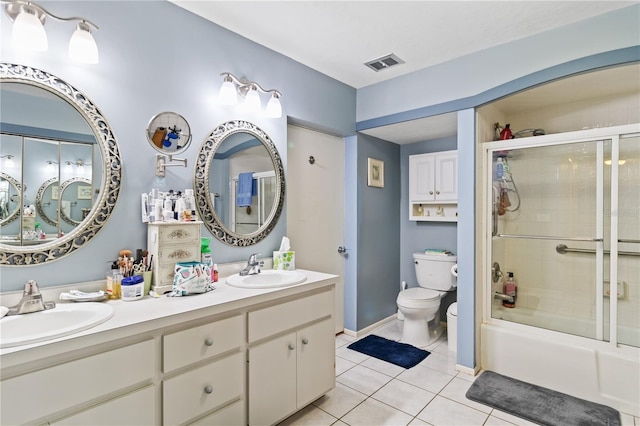 full bathroom with tile patterned flooring, vanity, toilet, and enclosed tub / shower combo