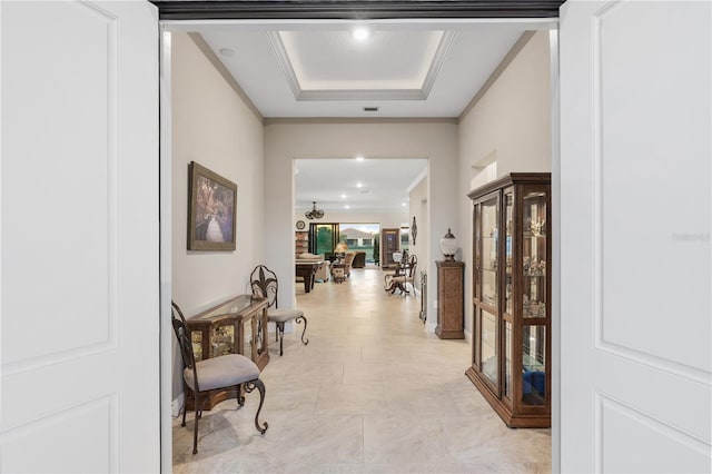 hall featuring crown molding and a tray ceiling