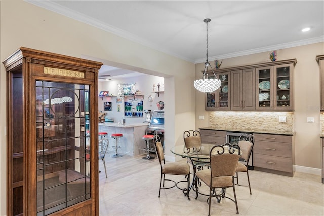 dining area featuring ornamental molding and bar area