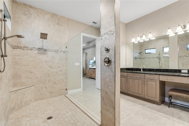 bathroom featuring vanity and tiled shower