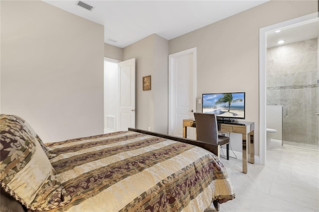 bedroom with light tile patterned floors and ensuite bath