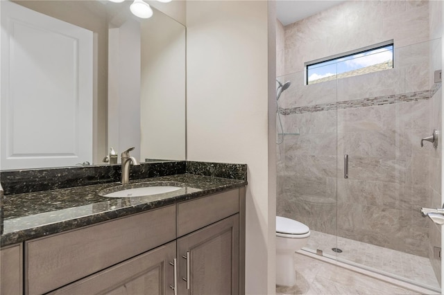 bathroom with vanity, toilet, and an enclosed shower