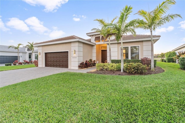 view of front of property featuring a garage and a front yard