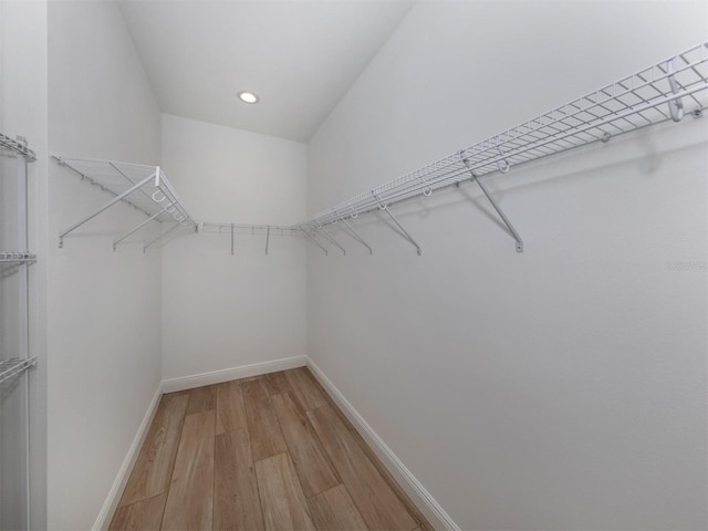 spacious closet with light hardwood / wood-style floors