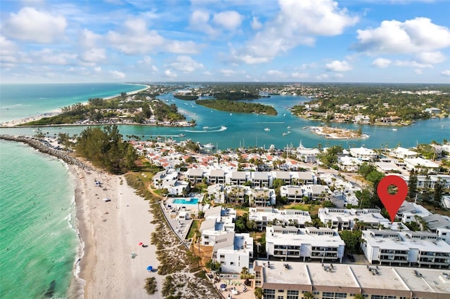 birds eye view of property with a water view and a beach view