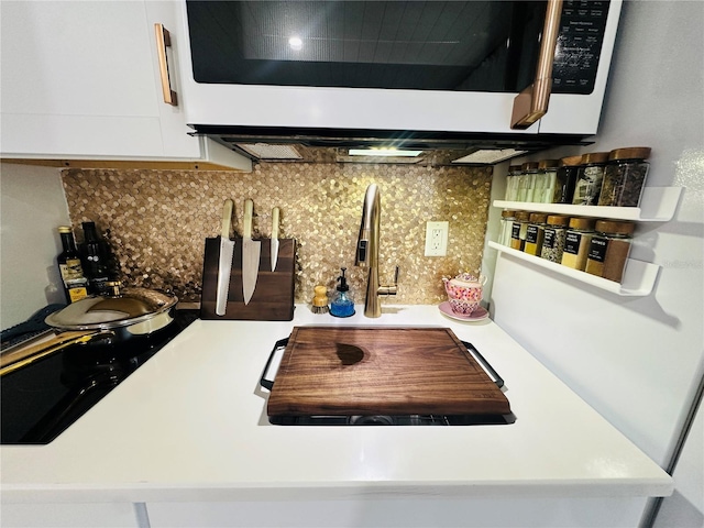 kitchen featuring decorative backsplash and white cabinetry