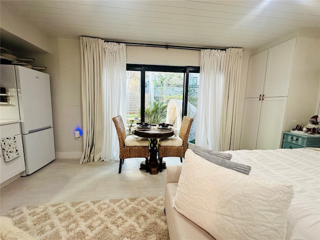 bedroom featuring wood ceiling and white refrigerator