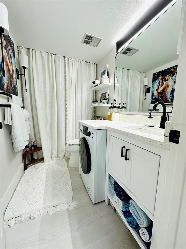 laundry area featuring washer / dryer and sink