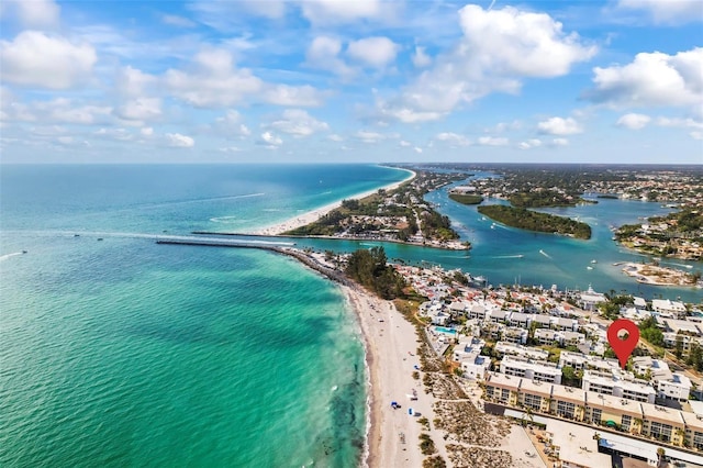 drone / aerial view with a water view and a beach view