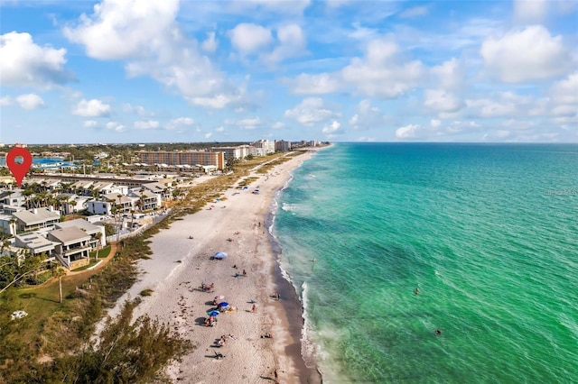 bird's eye view featuring a water view and a beach view